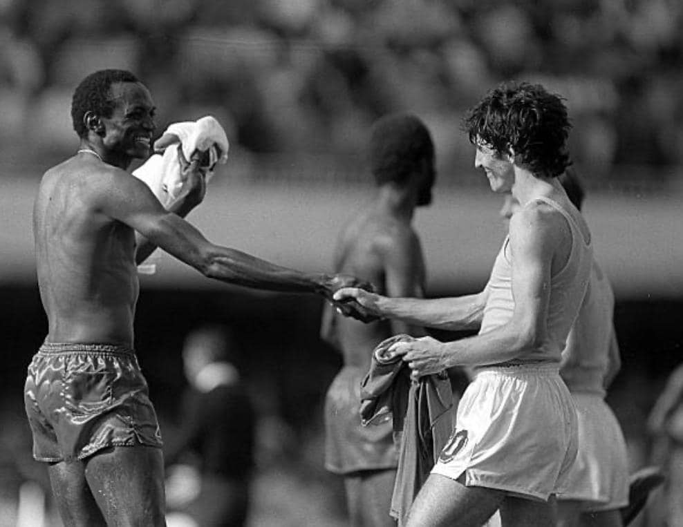 Cameroon's Michel Kaham gleefully exchanges shirts and shakes hands with Italy's Paolo Rossi at the end of their Group A match